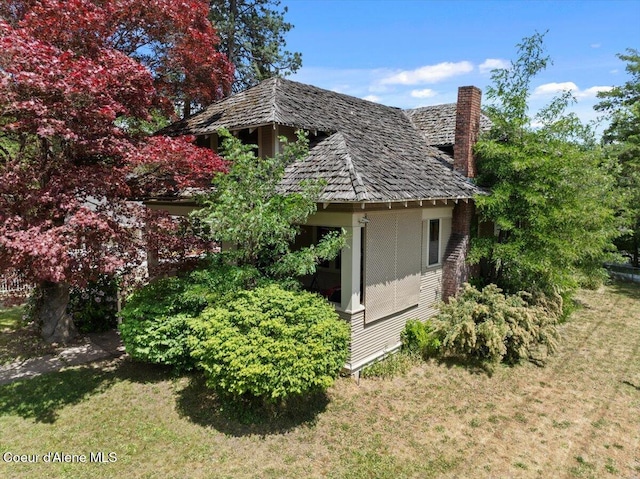 602 N Government Way, Coeur Dalene, ID 83814 - view of side of home featuring a yard and a chimney