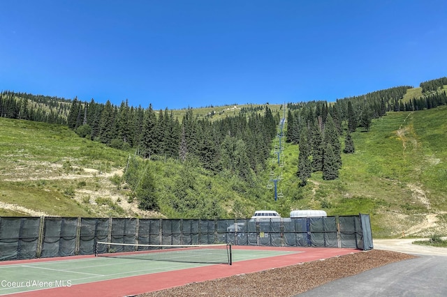 677 Telemark Rd Unit 1, Sandpoint, ID 83864 - view of tennis court with a wooded view