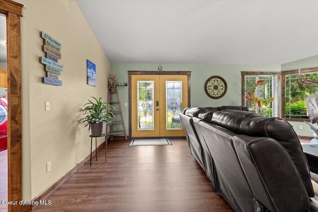 438 Berry Hl, Cocolalla, ID 83813 - living area with healthy amount of natural light, french doors, dark wood-style floors, lofted ceiling, and washer / dryer