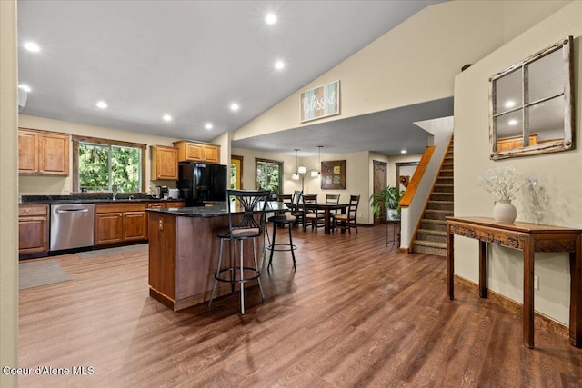 438 Berry Hl, Cocolalla, ID 83813 - kitchen with stainless steel dishwasher, freestanding refrigerator, a kitchen island, wood finished floors, and recessed lighting