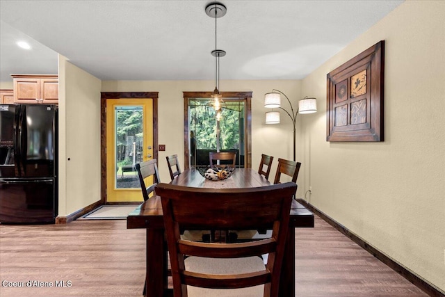 438 Berry Hl, Cocolalla, ID 83813 - dining space featuring baseboards and light wood-style flooring