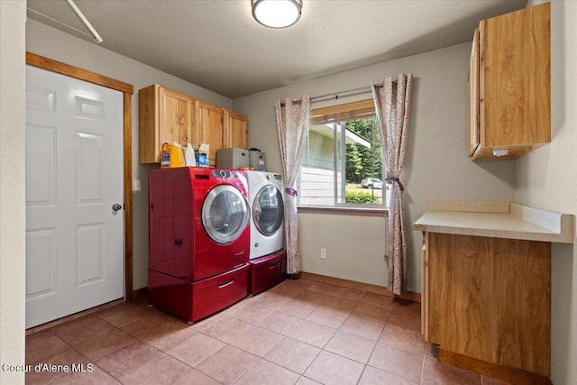 438 Berry Hl, Cocolalla, ID 83813 - laundry area featuring cabinet space, independent washer and dryer, light tile patterned floors, and a textured ceiling