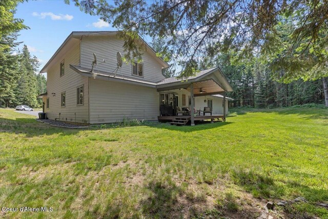 438 Berry Hl, Cocolalla, ID 83813 - rear view of property featuring a lawn, a ceiling fan, and a deck