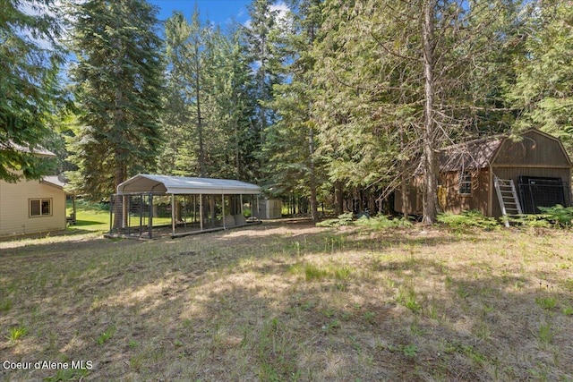438 Berry Hl, Cocolalla, ID 83813 - view of green lawn featuring a carport and an outbuilding