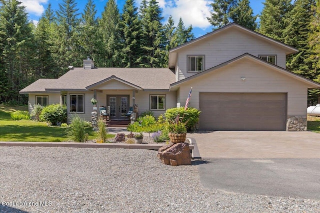 438 Berry Hl, Cocolalla, ID 83813 - view of front facade with french doors, driveway, an attached garage, and a chimney