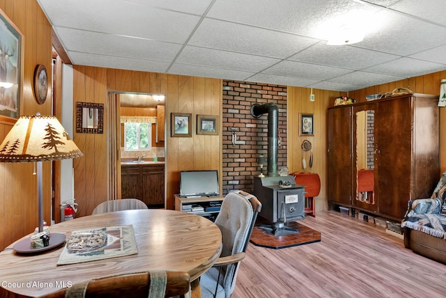 498 Lakeview Rd, Bayview, ID 83803 - office space featuring a wood stove, wood finished floors, wood walls, and a drop ceiling