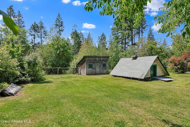 498 Lakeview Rd, Bayview, ID 83803 - view of grassy yard with a storage shed and view of scattered trees