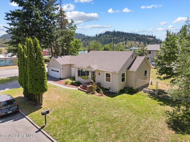 2224 E Coeur D Alene Ave, Coeur Dalene, ID 83814 - ranch-style home featuring an attached garage, a mountain view, driveway, and a shingled roof