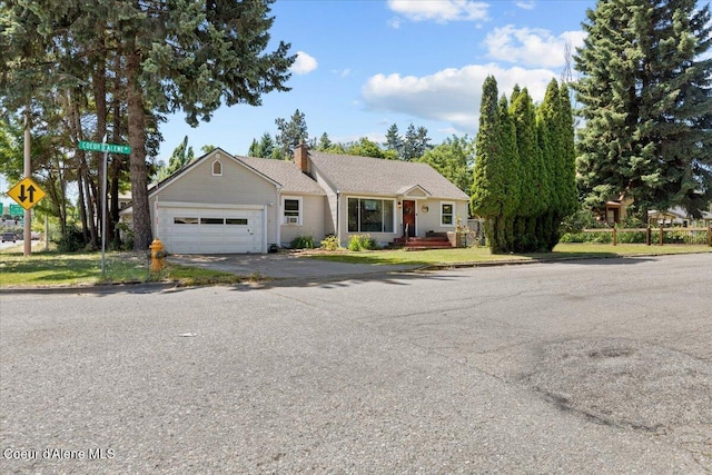 2224 E Coeur D Alene Ave, Coeur Dalene, ID 83814 - ranch-style home with an attached garage, a chimney, and driveway