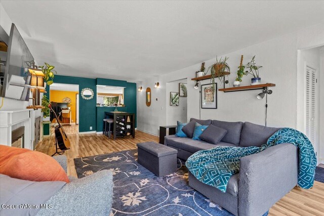 2224 E Coeur D Alene Ave, Coeur Dalene, ID 83814 - living room with wood finished floors and a glass covered fireplace