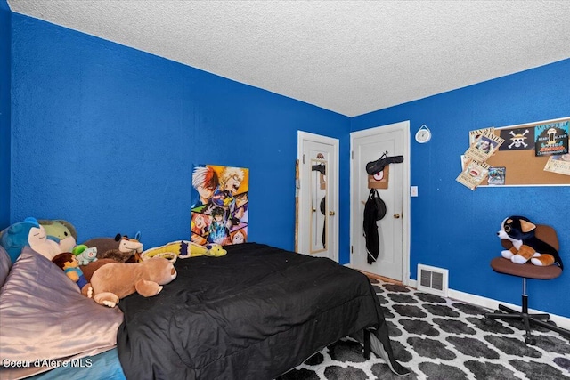 2224 E Coeur D Alene Ave, Coeur Dalene, ID 83814 - bedroom featuring a textured ceiling and baseboards