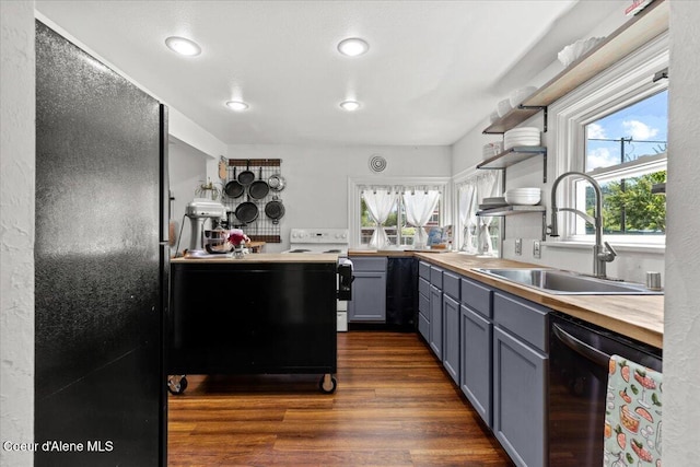 2224 E Coeur D Alene Ave, Coeur Dalene, ID 83814 - kitchen with range with electric stovetop, dishwashing machine, dark wood-type flooring, open shelves, and freestanding refrigerator