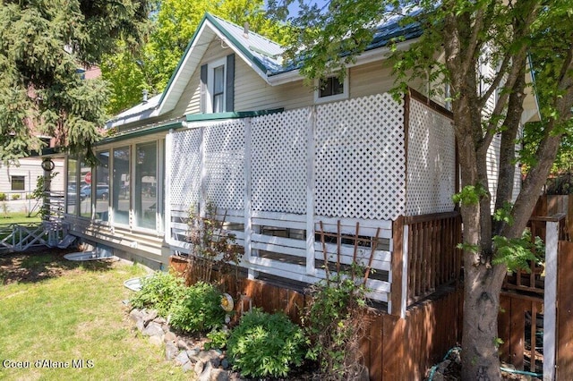 610 W Emma Ave, Coeur Dalene, ID 83814 - view of home's exterior with a metal roof, a sunroom, and a yard