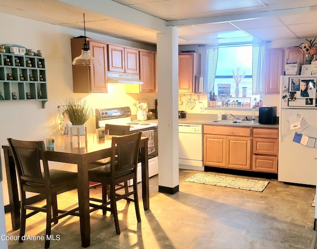 610 W Emma Ave, Coeur Dalene, ID 83814 - kitchen featuring white appliances, a drop ceiling, under cabinet range hood, light countertops, and pendant lighting