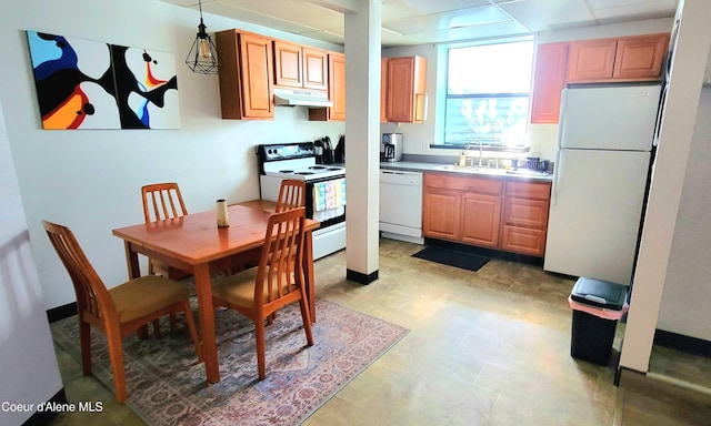 610 W Emma Ave, Coeur Dalene, ID 83814 - kitchen with white appliances, under cabinet range hood, hanging light fixtures, and light countertops