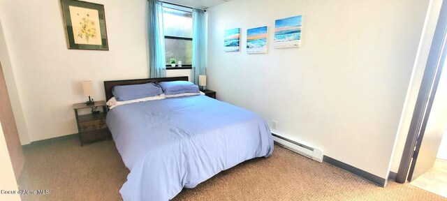 610 W Emma Ave, Coeur Dalene, ID 83814 - bedroom featuring a baseboard heating unit and light colored carpet