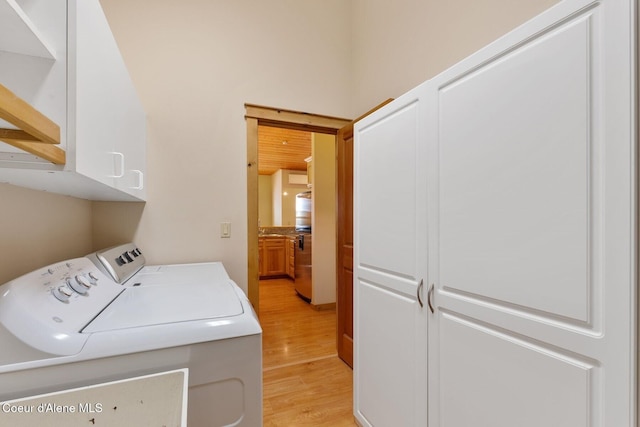 1625 Sequoia, Sandpoint, ID 83864 - laundry room with washing machine and dryer, cabinet space, and light wood-type flooring