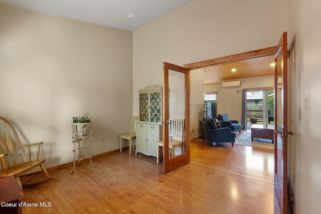 1625 Sequoia, Sandpoint, ID 83864 - sitting room with light wood-type flooring, french doors, an AC wall unit, and recessed lighting