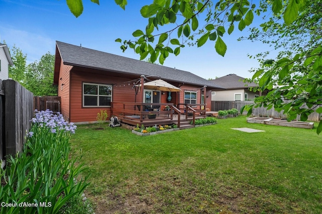 1625 Sequoia, Sandpoint, ID 83864 - back of house with a garden, a wooden deck, a fenced backyard, and roof with shingles