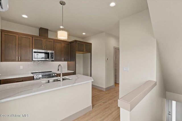 3026 Suzanne C, Coeur Dalene, ID 83815 - kitchen with stainless steel appliances, decorative backsplash, light wood finished floors, recessed lighting, and decorative light fixtures