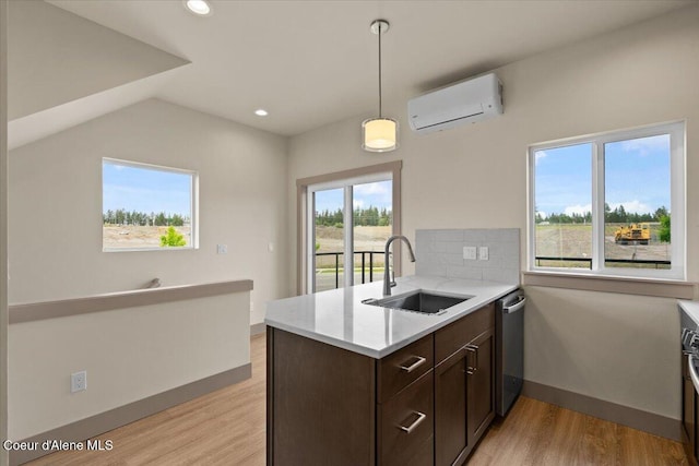 3026 Suzanne C, Coeur Dalene, ID 83815 - kitchen featuring an AC wall unit, stainless steel dishwasher, light wood-style floors, dark brown cabinetry, and recessed lighting