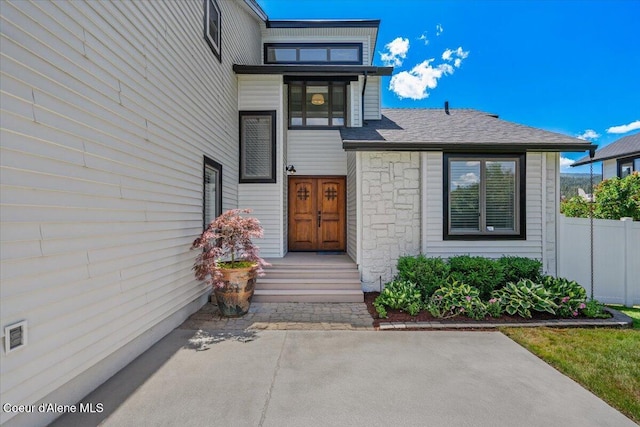 1922 E Rodkey Dr, Post Falls, ID 83854 - doorway to property with stone siding, a patio, and roof with shingles