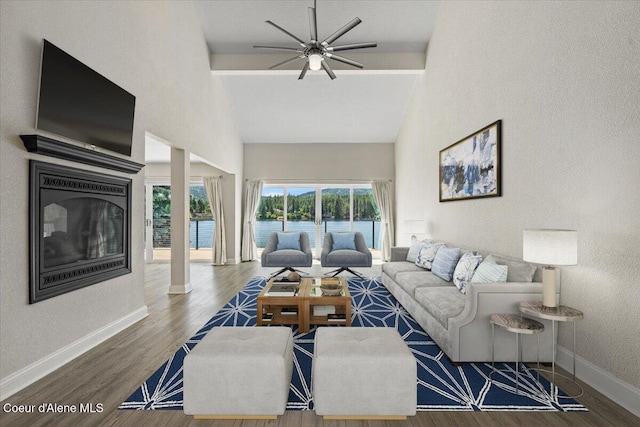 1922 E Rodkey Dr, Post Falls, ID 83854 - living area featuring ceiling fan, high vaulted ceiling, wood finished floors, a water view, and a textured wall