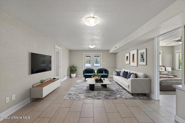 1922 E Rodkey Dr, Post Falls, ID 83854 - living area with a textured ceiling, french doors, healthy amount of natural light, wood tiled floors, and a ceiling fan