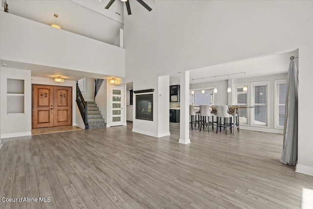 1922 E Rodkey Dr, Post Falls, ID 83854 - living area featuring wood finished floors, stairs, a ceiling fan, and a glass covered fireplace