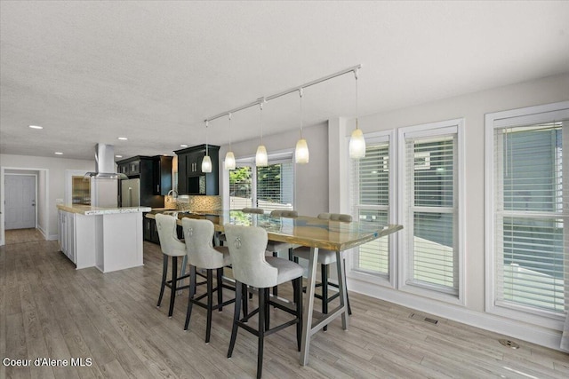 1922 E Rodkey Dr, Post Falls, ID 83854 - dining area with track lighting, light wood finished floors, recessed lighting, and a textured ceiling