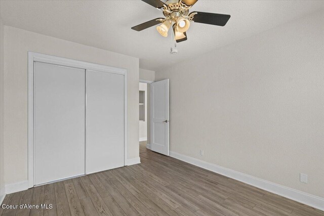 1922 E Rodkey Dr, Post Falls, ID 83854 - unfurnished bedroom with wood finished floors, a closet, and ceiling fan