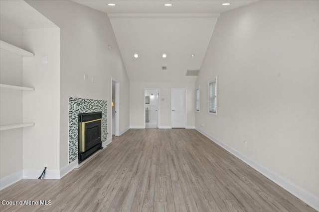 1922 E Rodkey Dr, Post Falls, ID 83854 - unfurnished living room featuring wood finished floors, a fireplace, high vaulted ceiling, and recessed lighting