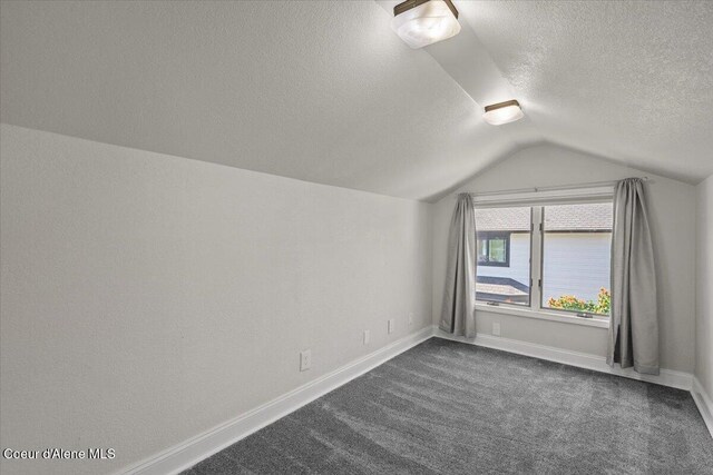 1922 E Rodkey Dr, Post Falls, ID 83854 - bonus room featuring a textured ceiling, vaulted ceiling, and dark colored carpet
