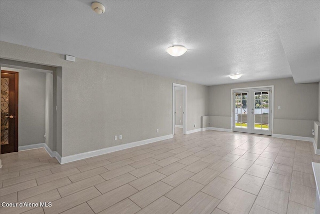 1922 E Rodkey Dr, Post Falls, ID 83854 - unfurnished room with a smoke detector, a textured ceiling, and french doors