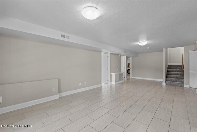 1922 E Rodkey Dr, Post Falls, ID 83854 - finished below grade area featuring a textured ceiling, stairway, and washer / dryer