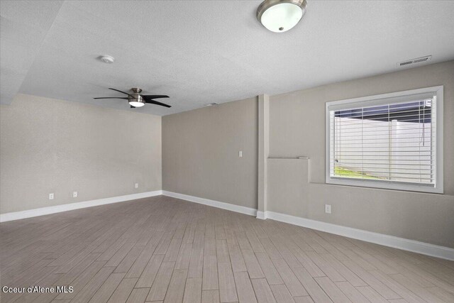 1922 E Rodkey Dr, Post Falls, ID 83854 - spare room with a textured ceiling, ceiling fan, wood finished floors, and a smoke detector