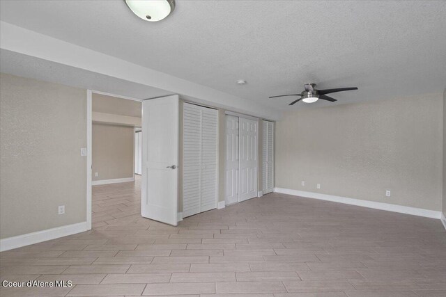 1922 E Rodkey Dr, Post Falls, ID 83854 - unfurnished bedroom with a textured ceiling, wood finished floors, and multiple closets