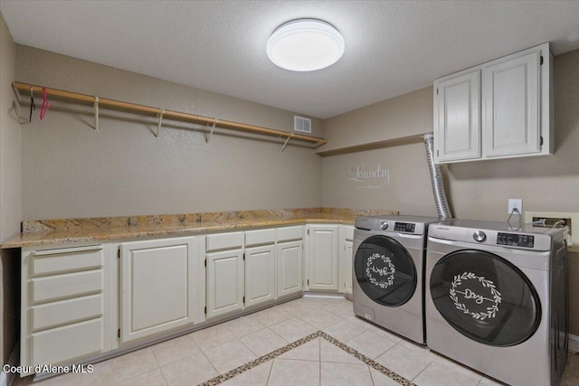 1922 E Rodkey Dr, Post Falls, ID 83854 - laundry area with cabinet space, independent washer and dryer, light tile patterned floors, and a textured ceiling