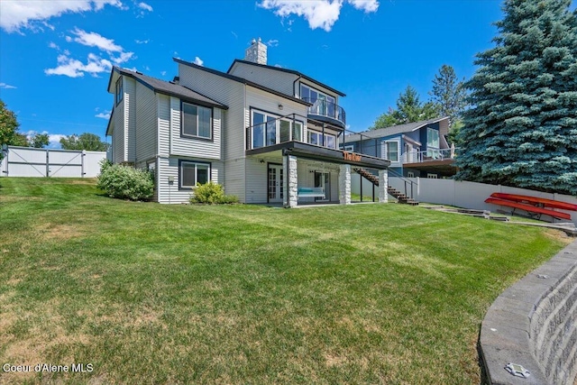 1922 E Rodkey Dr, Post Falls, ID 83854 - rear view of house featuring stairs, a chimney, and a deck