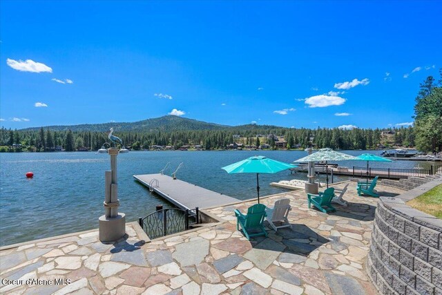 1922 E Rodkey Dr, Post Falls, ID 83854 - view of pool featuring a wooded view, a water and mountain view, a boat dock, and a patio