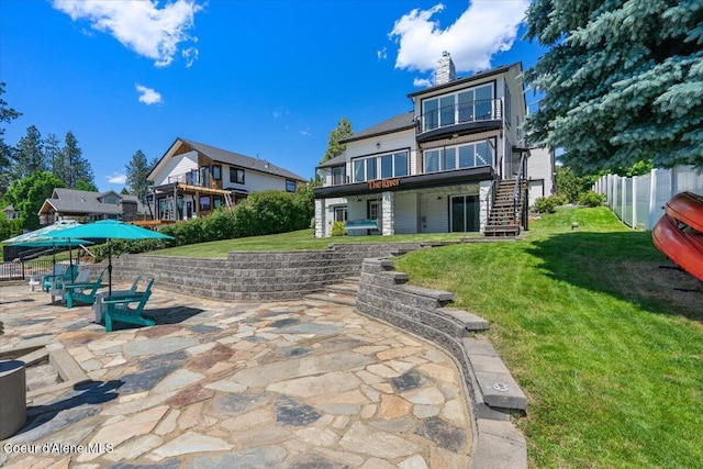 1922 E Rodkey Dr, Post Falls, ID 83854 - rear view of house featuring stairway, a patio area, a deck, and a chimney