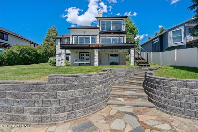 1922 E Rodkey Dr, Post Falls, ID 83854 - rear view of house featuring stairs, a deck, and a chimney