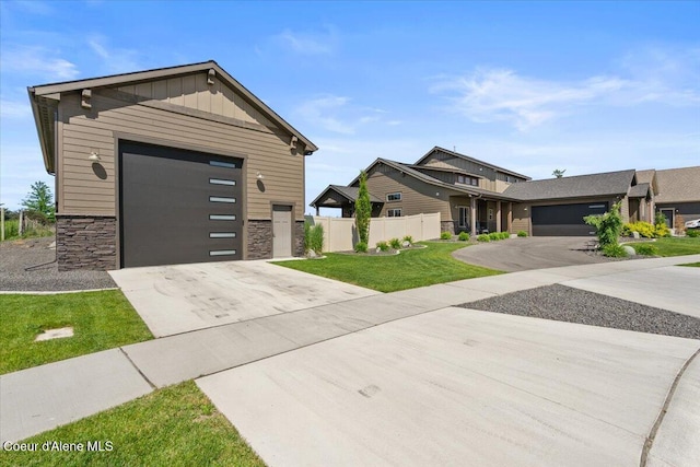 3811 N Foxtail Rd, Post Falls, ID 83854 - view of front of house with concrete driveway, stone siding, board and batten siding, and a garage