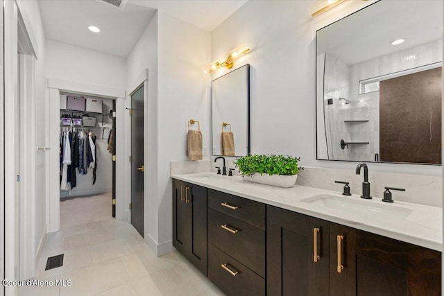 3811 N Foxtail Rd, Post Falls, ID 83854 - full bath with double vanity, a spacious closet, tiled shower, and tile patterned flooring