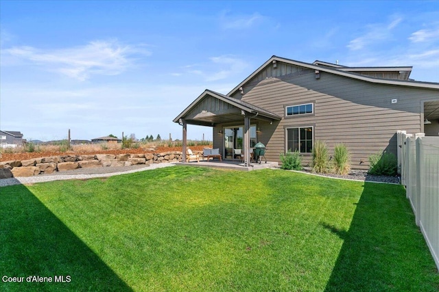 3811 N Foxtail Rd, Post Falls, ID 83854 - back of house featuring a patio area and board and batten siding
