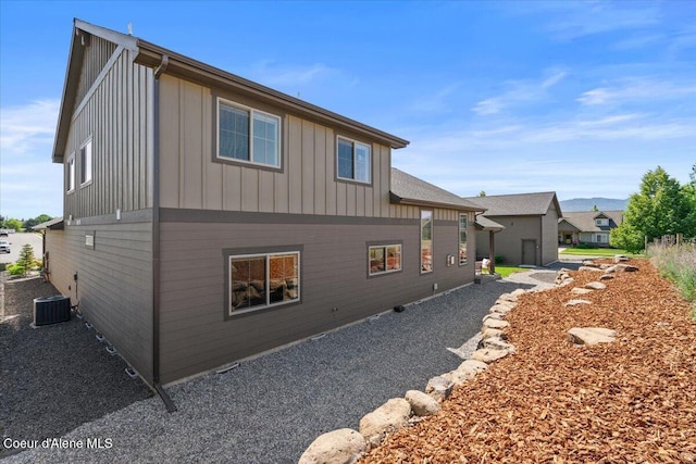 3811 N Foxtail Rd, Post Falls, ID 83854 - view of side of property with board and batten siding and a central AC unit