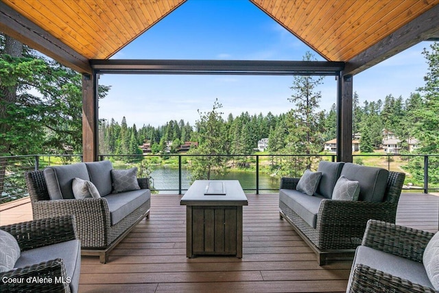 11667 N Eastshore Dr, Hayden, ID 83835 - wooden terrace featuring outdoor lounge area, a water view, and view of wooded area