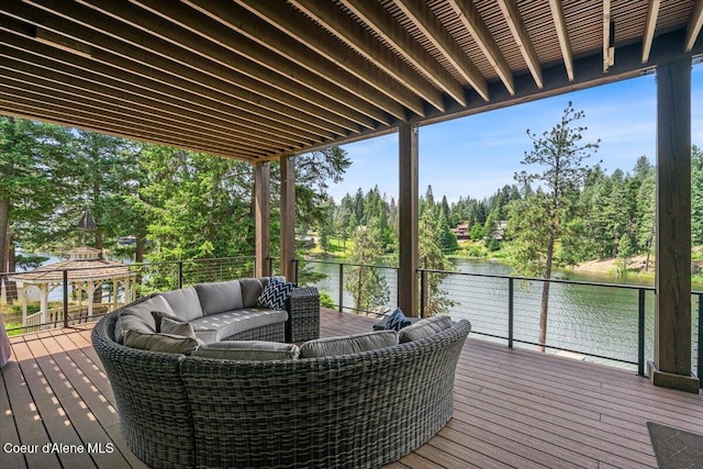 11667 N Eastshore Dr, Hayden, ID 83835 - deck with a water view, view of scattered trees, and an outdoor hangout area