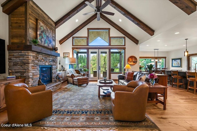 11667 N Eastshore Dr, Hayden, ID 83835 - living area with beamed ceiling, wood finished floors, ceiling fan, recessed lighting, and high vaulted ceiling