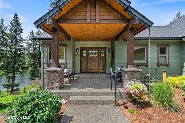 11667 N Eastshore Dr, Hayden, ID 83835 - view of exterior entry with covered porch and roof with shingles